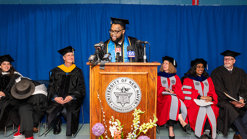 Alpha Jalloh talks at the podium.