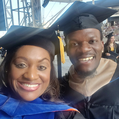 Watson Joseph ’22 MBA with the Alumni Bell at Commencement.