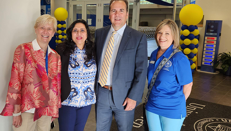 Ranjana Maitra '91 MBA and her fellow University staff members.
Left to right: Cindy Gallatin, Ranjana Maitra, interim president Dr. Sheahon Zenger, and Anne Whitman.