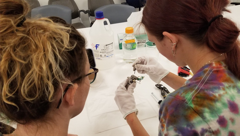 Mackenzie Pavlik ’23 (right) and Abby Veeser ’23 M.S. cleaning the GC-MS.