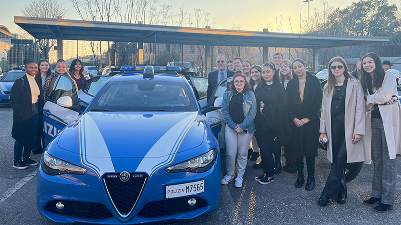 Chargers with an Italian police car outside the station.