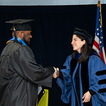 Zelda Roland, Ph.D., founding director of the University of New Haven Prison Education Program and the Yale Prison Education Initiative, congratulates graduate Hakim Jefferson '25 A.A. during the ceremony