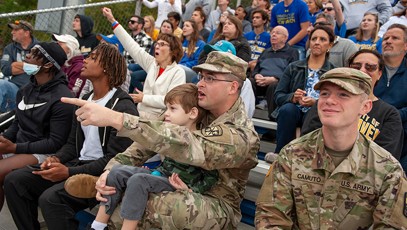 Members of Charger Nation cheering from the stands.