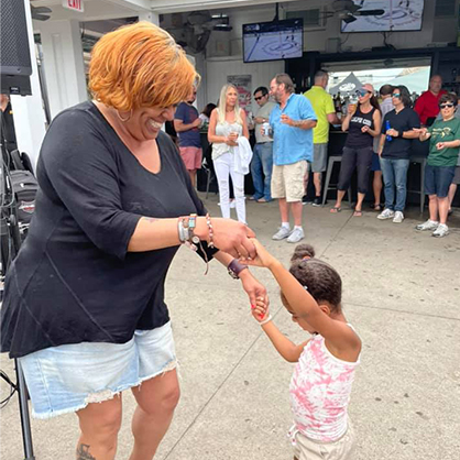 Taritha Middleton dancing with a little girl.