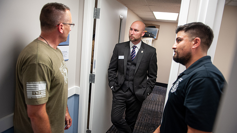 Ryan Noonan ’20, ’23 M.S. (center) in the University’s Veteran Success Center.