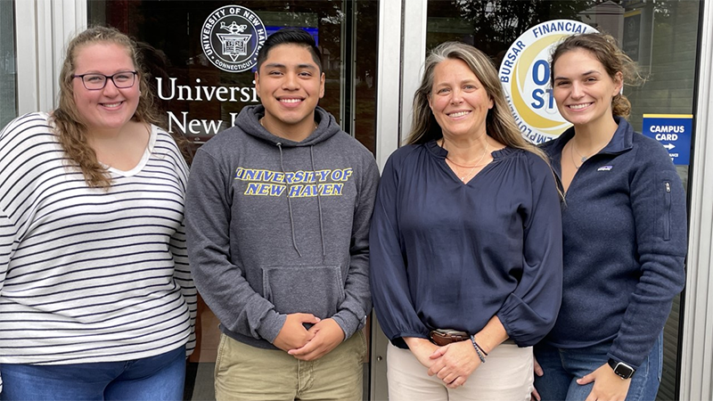 Student Financial Wellness Peer Educators at One Stop in Bergami Hall; Lexie Lajoie, Simon Romero, Vanessa Ort, Presley Hill.