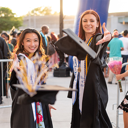 New graduates celebrate together after the afternoon Commencement ceremony. 