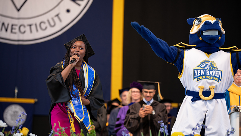 Kiana White ’23, ’24 M.S. and Charlie welcome everyone to the afternoon Commencement ceremony.