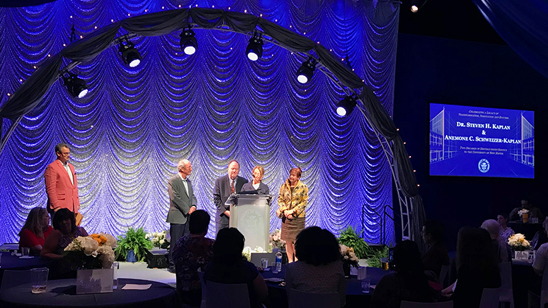 Dorinda Borer ’92 MBA and Kevin Ryan ’90 M.A., present a citation to the Kaplans.