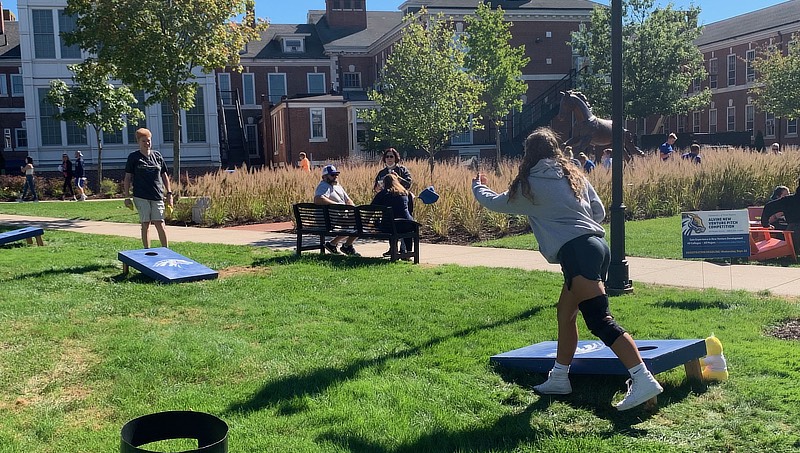 Image of families playing corn hole.