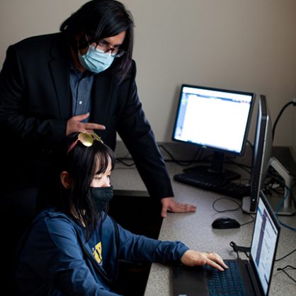 Image of Vahid Behzadan, Ph.D., and a student.