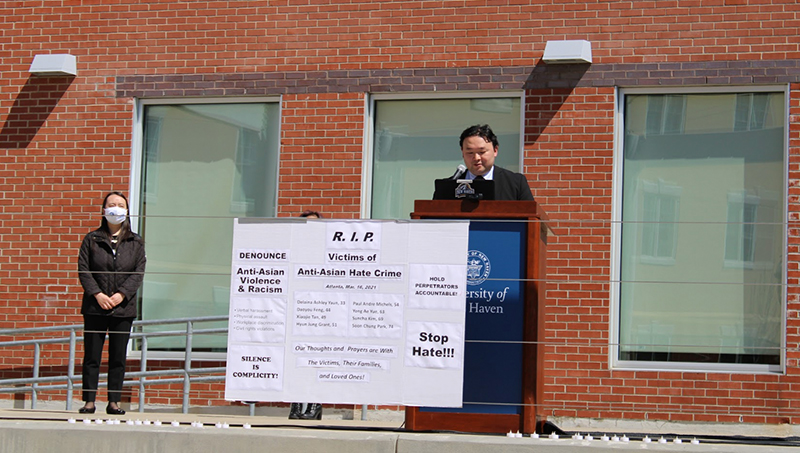 A speaker is addressing a crowd at a podium.