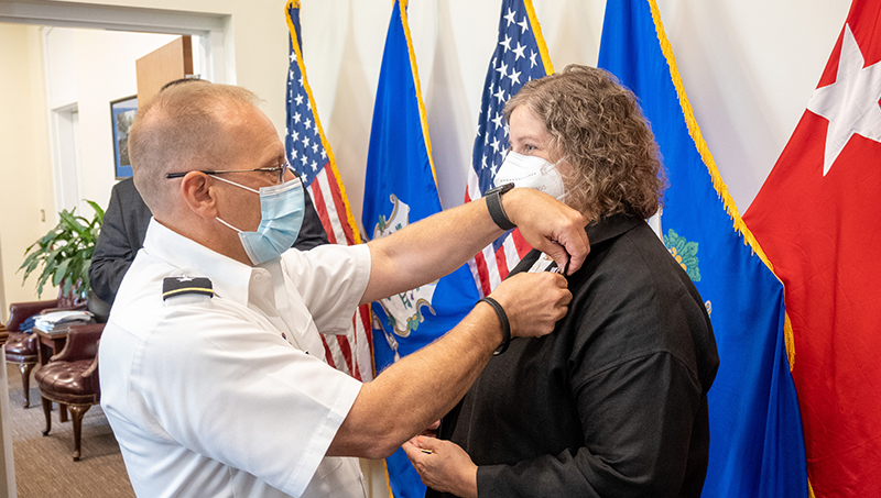 Liberty Page shaking hands with a service member.