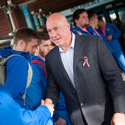 Sam Sorbello shaking hands with students. 

