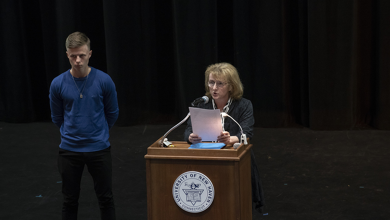 Adam Lindstrom ’25 and Eva Sapi, Ph.D., read a tribute to Raoul Wallenberg.