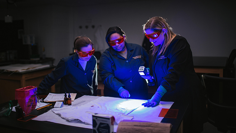 Claire Glynn, Ph.D. (right), and her students before the pandemic.