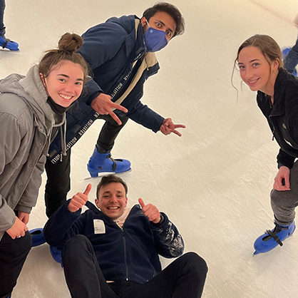 Andreas Xenofontos ’23 M.S. (on ground) tries ice skating for the first time.