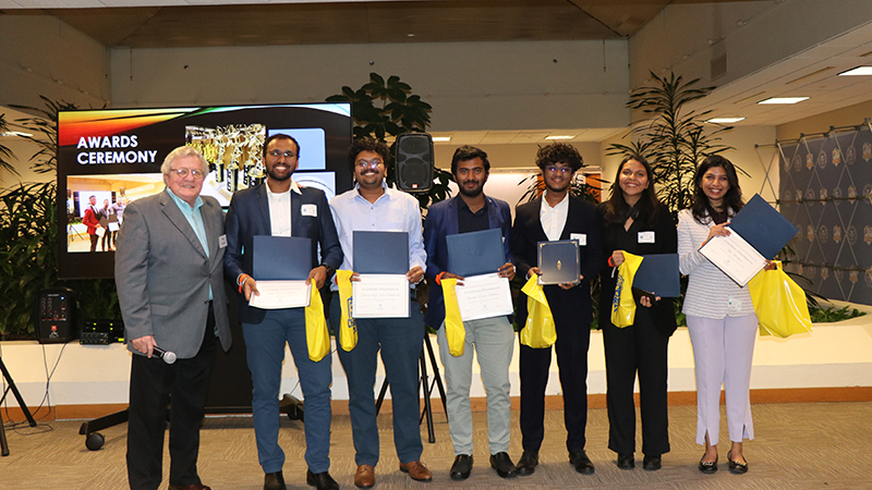 Members of DivergeX with Dr. Mo Cayer (left) at the competition.