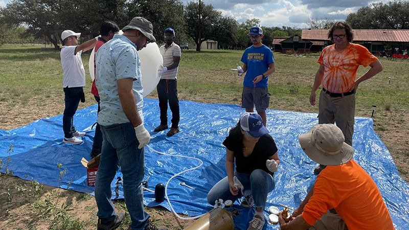 The researchers prepare a balloon for launch. 