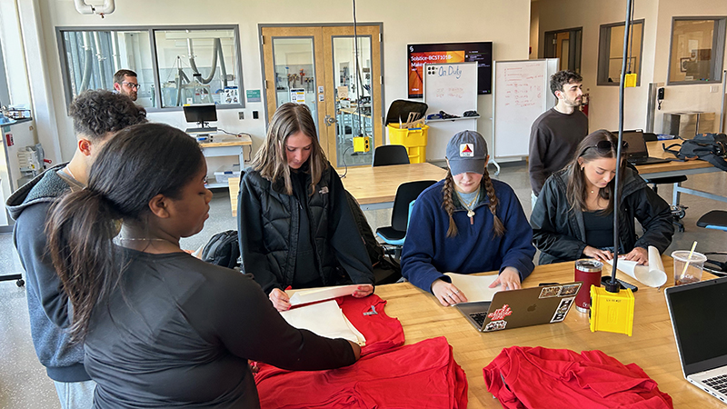 Chargers get t-shirts ready for Fresh Check Day.