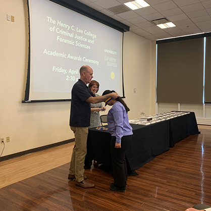 Dr. David Schroeder presented Honors medallions to students. 