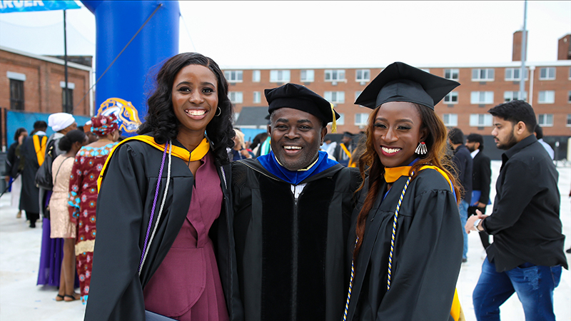 New graduates celebrate with Dr. Kagya Amoako (center)