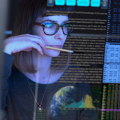 A woman working at a computer screen.